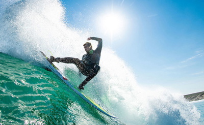 Surfer checking the fit of a wetsuit